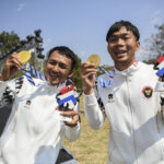 Atlet balap sepeda Indonesia Nurfendi (kanan) dan pilotnya Mufti Fadilah (kiri) menunjukkan medali emas yang mereka terima setelah berhasil mengalahkan lawan-lawannya dalam kategori Road Cycling Men's B - Time Trial di ASEAN Para Games 2025 di Suranaree Un